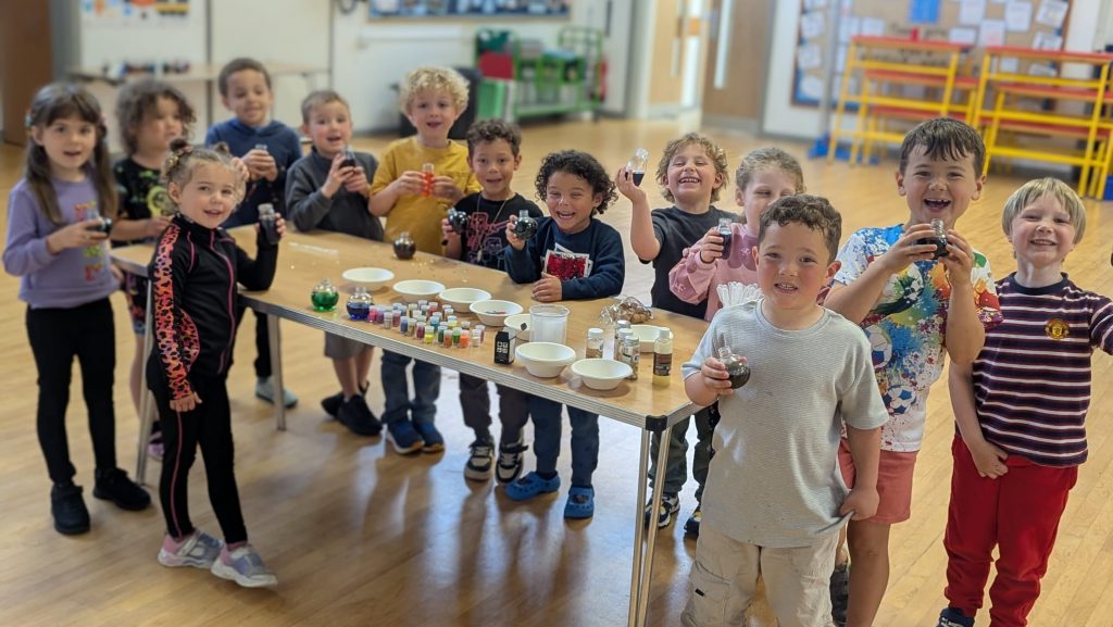 group of students in the holiday club doing some arts and crafts