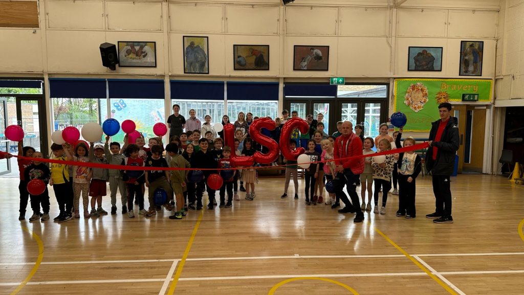 group of students in the holiday club celebrating with balloons
